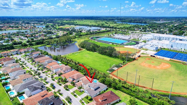 birds eye view of property with a water view