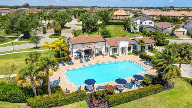 view of pool featuring a patio and a yard