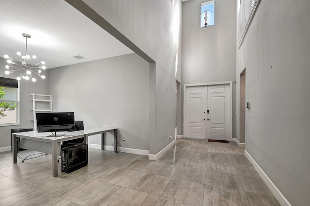 entrance foyer featuring an inviting chandelier and a towering ceiling