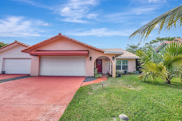 view of front of house featuring a garage and a front lawn