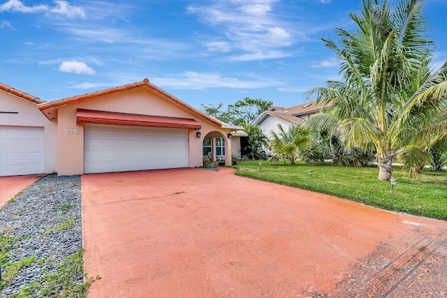 view of front of house with a front yard and a garage