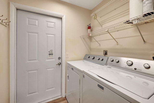 washroom featuring light wood-type flooring and washing machine and clothes dryer