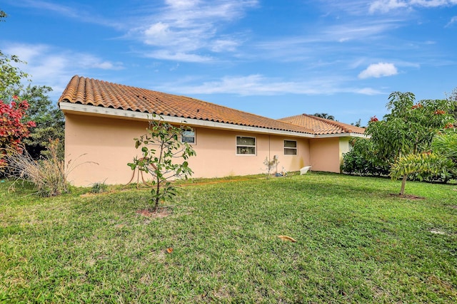 rear view of property with a lawn