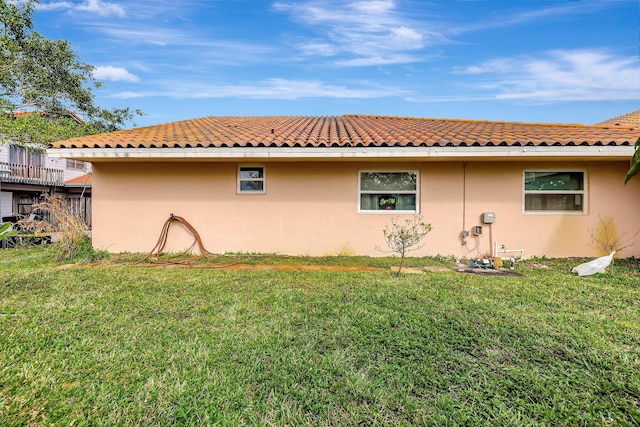 view of side of home with a yard