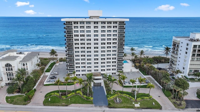 bird's eye view featuring a water view and a beach view