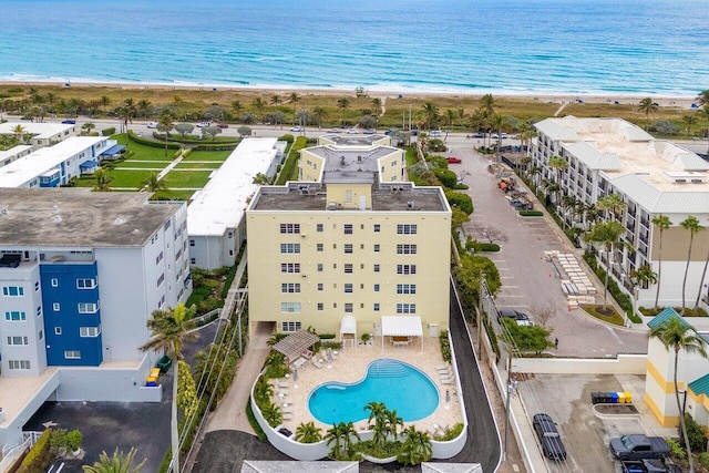 drone / aerial view with a beach view and a water view