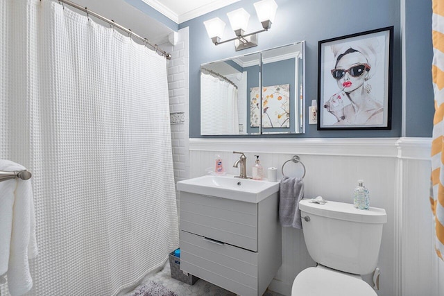 bathroom featuring vanity, toilet, walk in shower, and crown molding