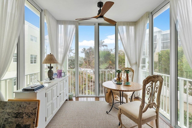 sunroom / solarium featuring ceiling fan