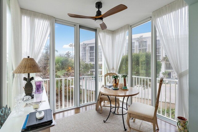 sunroom with a wealth of natural light and ceiling fan