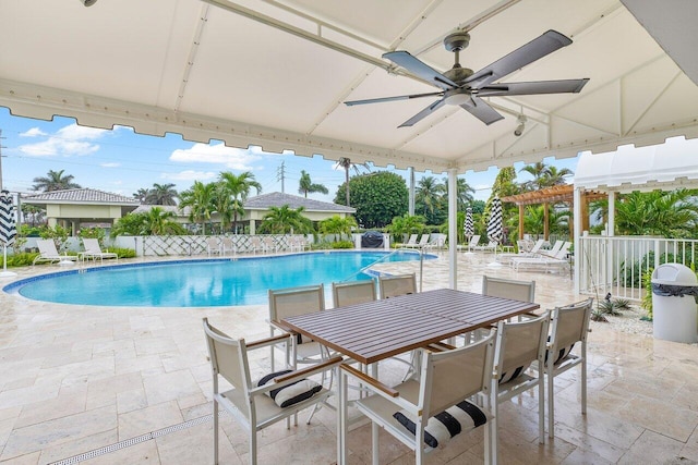 view of pool with ceiling fan, a pergola, and a patio