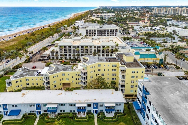 bird's eye view featuring a water view and a beach view