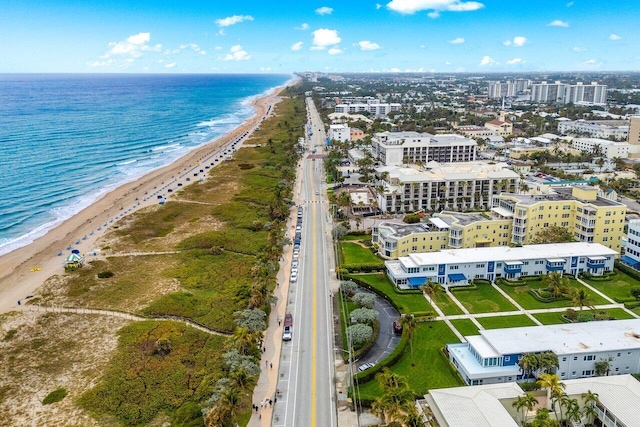 aerial view with a water view and a view of the beach