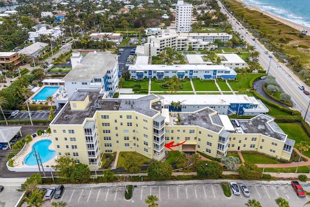 drone / aerial view with a water view and a view of the beach