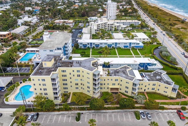 birds eye view of property featuring a water view and a view of the beach