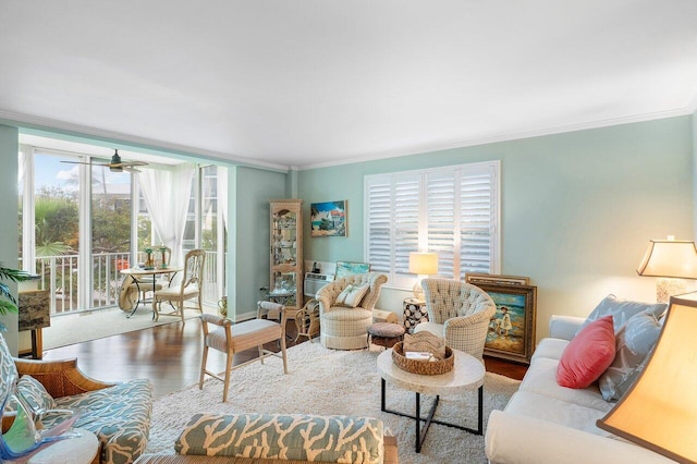 living room with hardwood / wood-style flooring, plenty of natural light, ornamental molding, and ceiling fan