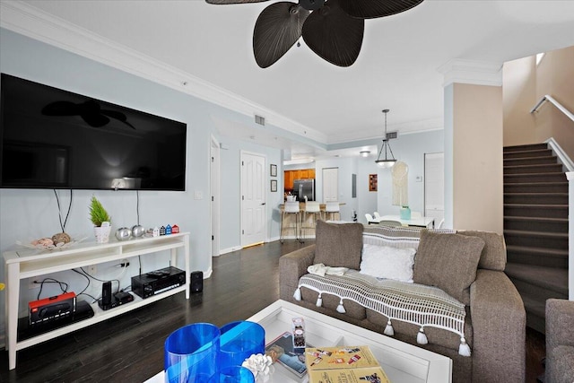 living room featuring ceiling fan, ornamental molding, and dark hardwood / wood-style floors