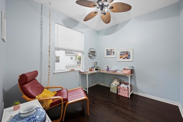 living area featuring ceiling fan and dark hardwood / wood-style flooring