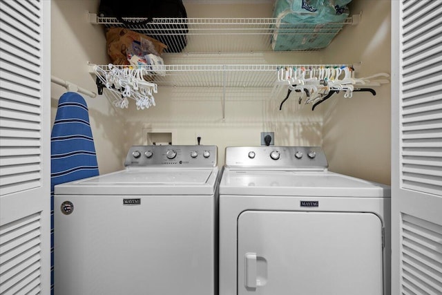 clothes washing area with separate washer and dryer