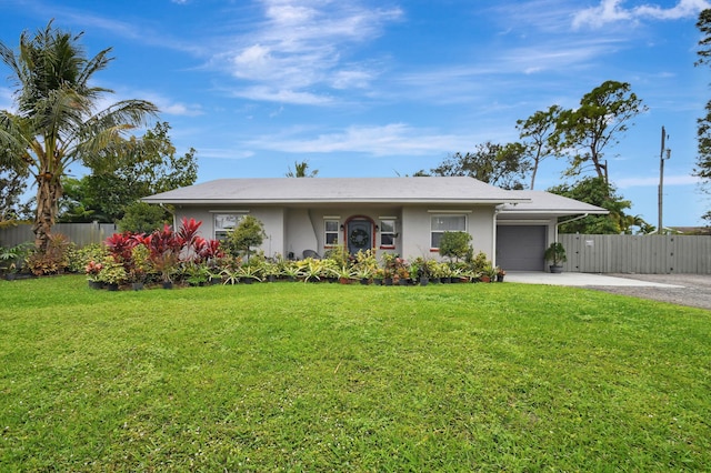 ranch-style home with a front lawn and a garage