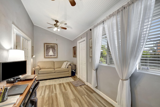 office space featuring light hardwood / wood-style floors, ornamental molding, and vaulted ceiling