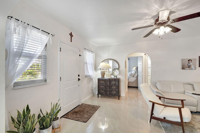 tiled entryway with ceiling fan