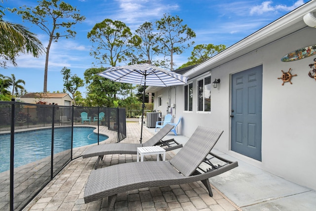 view of pool featuring a patio area and central air condition unit