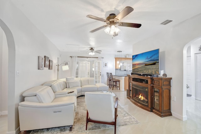 tiled living room featuring ceiling fan