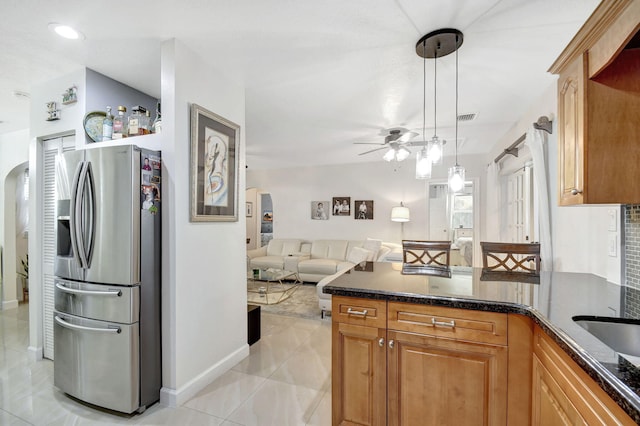 kitchen with stainless steel fridge with ice dispenser, ceiling fan, light tile patterned floors, and decorative light fixtures