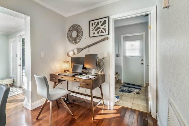 office with light hardwood / wood-style flooring and ornamental molding