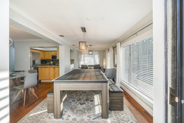 game room with crown molding and wood-type flooring