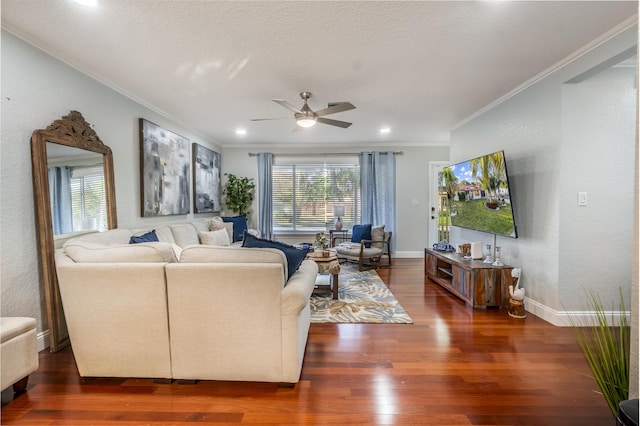 living room with dark hardwood / wood-style floors, ceiling fan, and crown molding