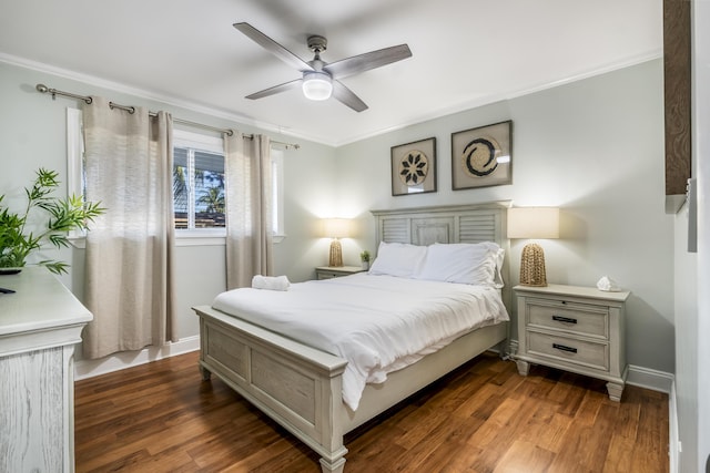 bedroom featuring dark hardwood / wood-style floors, ceiling fan, and crown molding