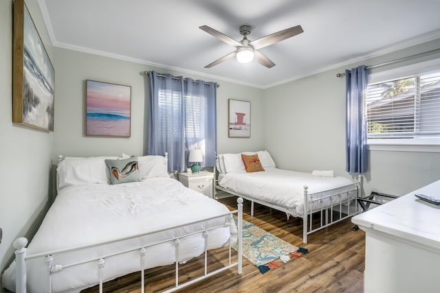 bedroom with dark wood-type flooring, ceiling fan, and ornamental molding