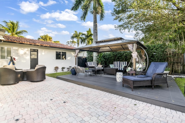 view of patio with a gazebo, outdoor lounge area, and a deck