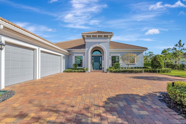 mediterranean / spanish house featuring a garage