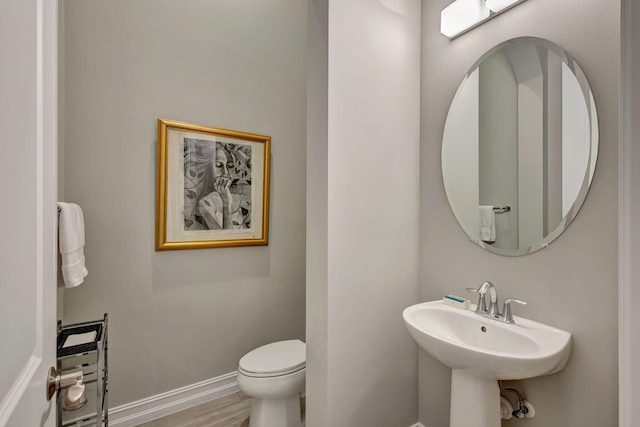 bathroom with sink, wood-type flooring, and toilet