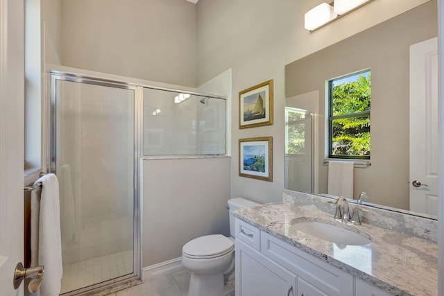 bathroom with tile patterned floors, vanity, toilet, and a shower with shower door