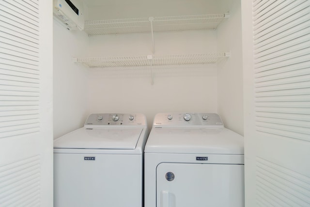 clothes washing area with washer and clothes dryer