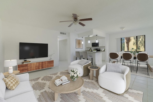 living room featuring light tile patterned floors and ceiling fan