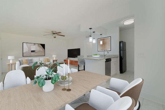 dining area featuring ceiling fan and sink