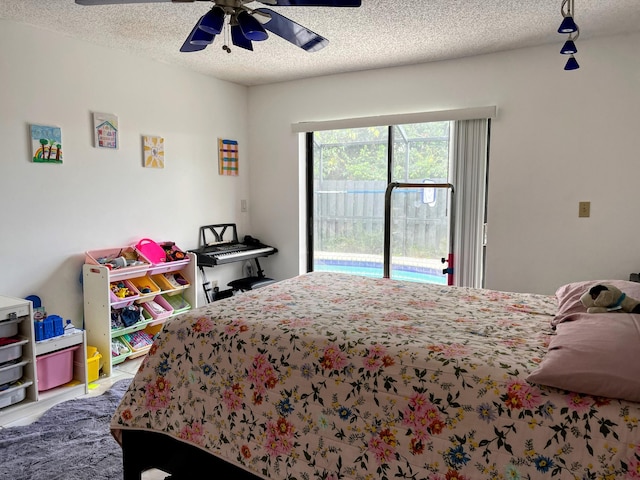 bedroom featuring ceiling fan, carpet floors, a textured ceiling, and access to exterior