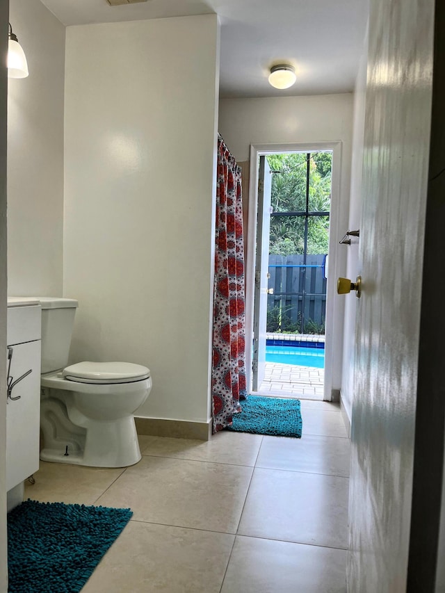 bathroom featuring toilet and tile patterned flooring