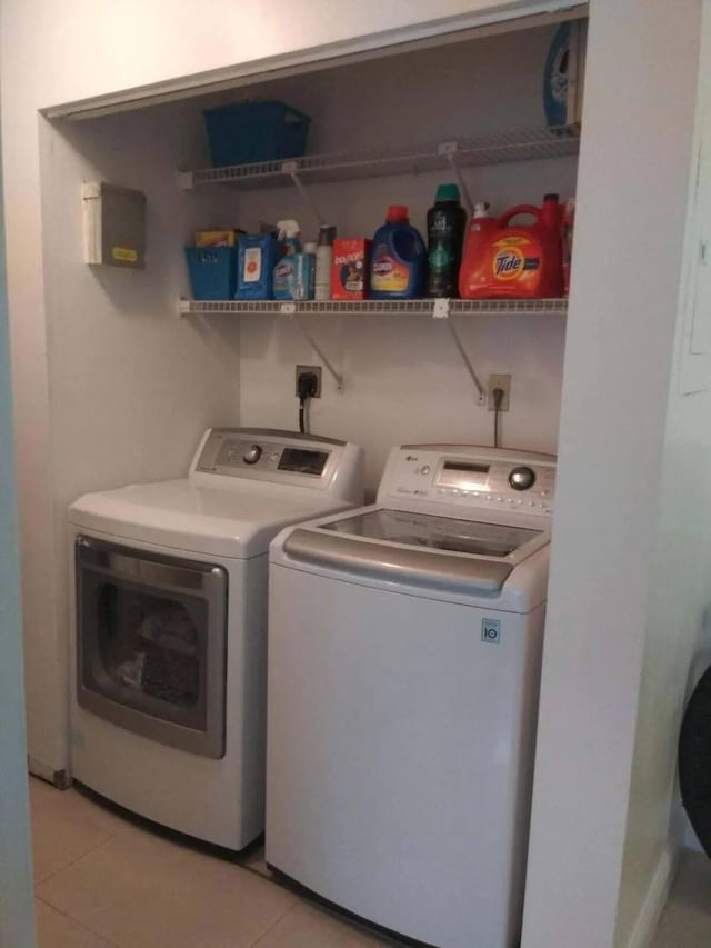 washroom featuring light tile patterned flooring and separate washer and dryer