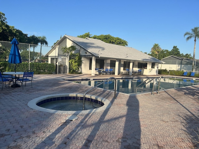 view of pool featuring a community hot tub and a patio