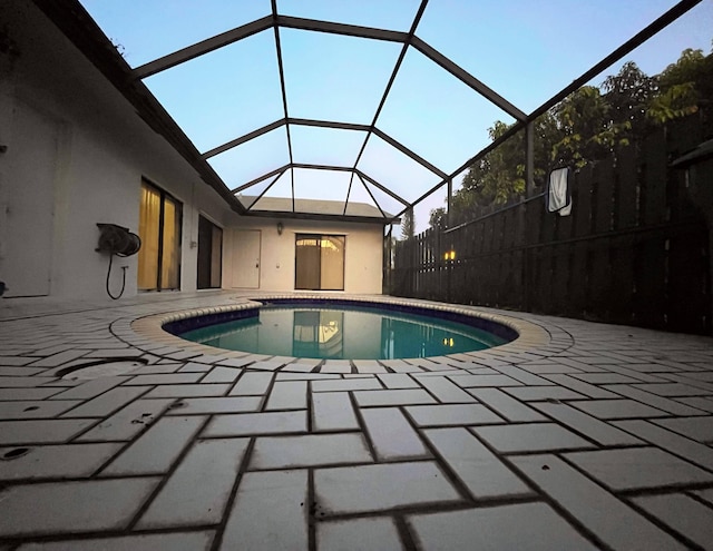 view of pool featuring a patio area and glass enclosure