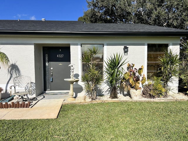 property entrance with a yard