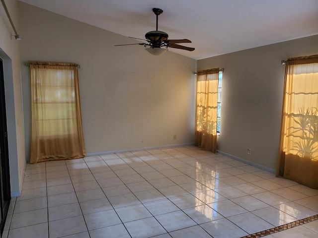 unfurnished room with ceiling fan, vaulted ceiling, and light tile patterned flooring