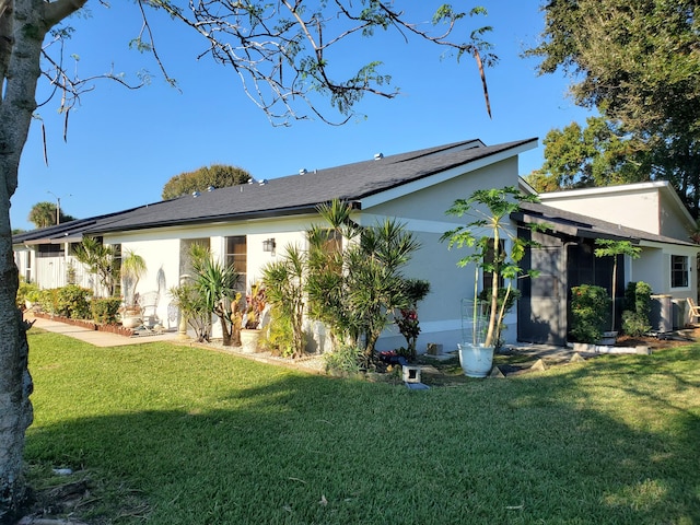 rear view of house featuring a yard