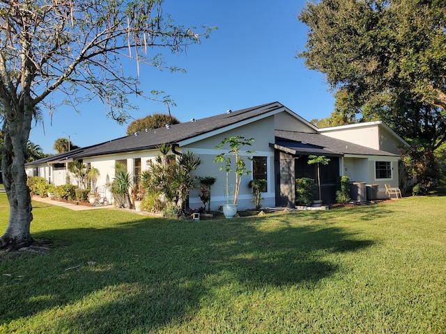 rear view of house with a yard