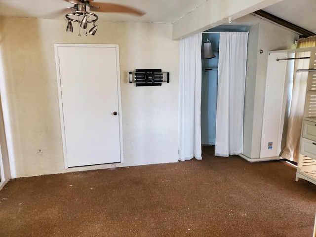 interior space featuring ceiling fan and carpet